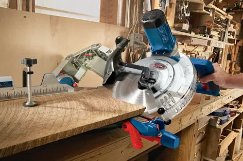 Bosch circular saw cutting wood with blade visible, workshop background.