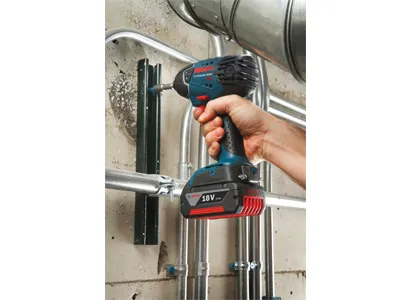 Bosch 18V impact driver being used to attach a bracket.