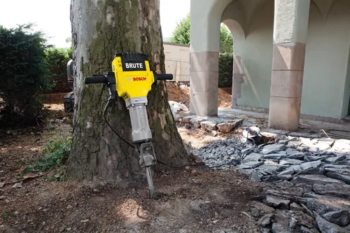 Bosch BRUTE jackhammer next to a tree.