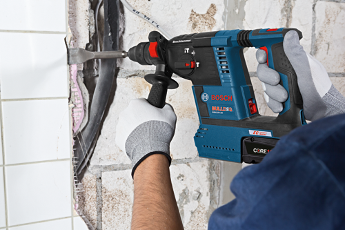 Bosch BULLDOG GBH18V-26 rotary hammer being used to break tile and wall, with CORE1 battery.