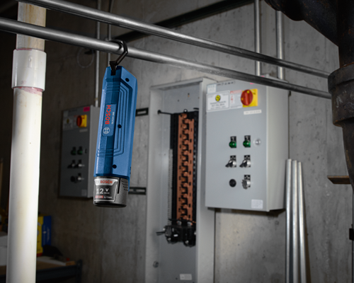 Bosch GLI12V-300 worklight, with a 12V battery that reads 2.0 Ah Li-Ion, hanging from a metal bar.