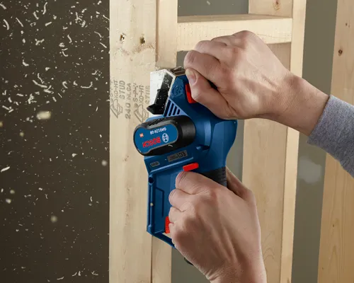 Bosch GHO12V-08 EC brushless motor tool is cutting wood; KD-HT STUD 240 NLGA S-P- KD-H7 STUB is visible.