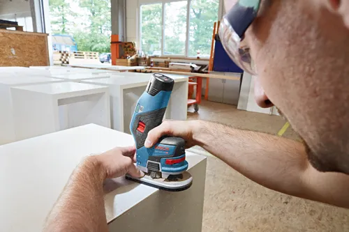A person using a Bosch GKF12V-25 HD sander.