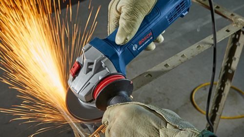 Bosch GWS10-45PD angle grinder being used, sparks visible.