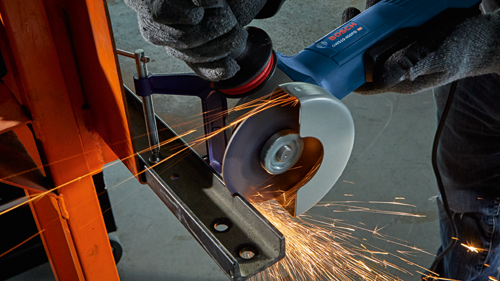 Bosch GWS10-450PD HD angle grinder cutting metal, creating sparks.