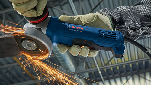 Bosch GWS10-45PD angle grinder being used to cut metal, with sparks visible.