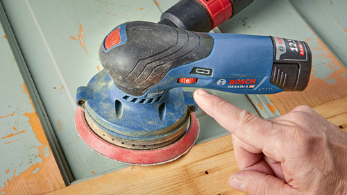 Bosch GEX12V-5 HD 12V sander, model GEX12V-5 HD, with a hand pointing to the speed selector.
