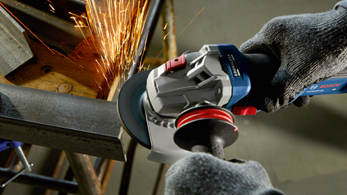 Bosch GWS18V-10 angle grinder cutting metal, producing sparks. GLOVES