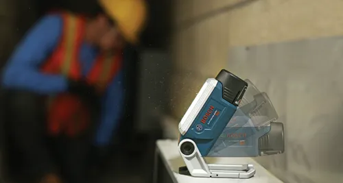 Bosch Lithium-Ion 12V work light, adjustable, with worker in background.