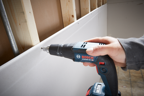 Bosch GTB18V-45 cordless drill being used to screw into a wall.