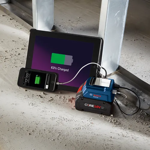 Bosch GAA18V-48 CORE18V charger charging an iPad and an iPhone with 63% charged.