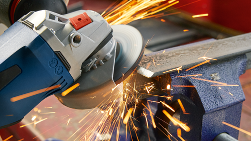 Metal being cut with an angle grinder, producing sparks.