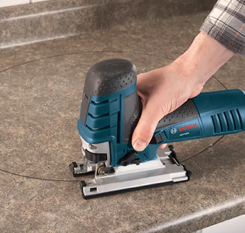 Bosch jigsaw cutting a circle on a countertop.