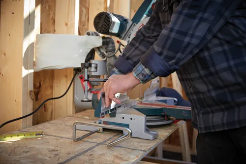 Man operating a Bosch miter saw.