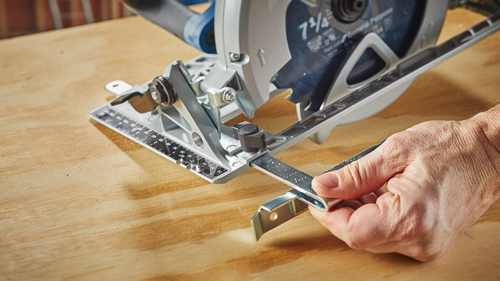 7 1/4" circular saw blade, with General Purpose, near a person's hand on a wooden surface.