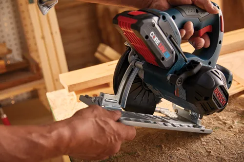 Bosch cordless circular saw, with "CORE 18V" battery pack, being held by two hands.
