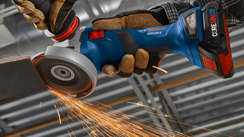 Bosch GWX18V-8 grinder being used on metal, with sparks visible. CORE18V 4 Ah battery visible. Hands in gloves.