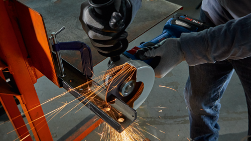 Bosch GWS18V-8 angle grinder cutting metal, sparks visible.