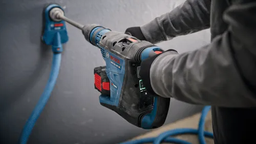 Bosch GBH18V-40C HD hammer drill with "TURBO BRUSHLESS" text and Auto Favorite settings, attached to a blue hose.