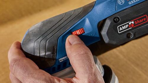 A hand adjusting the speed setting "6" on a Bosch tool; "AMP Share" is also visible.