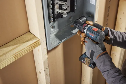Bosch GSR18V-800FC cordless drill being used to install an electrical panel.