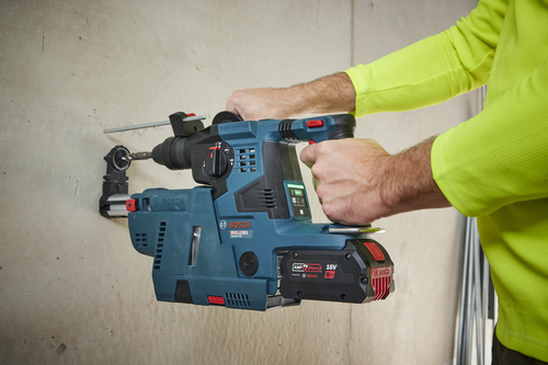 Bosch BULLDAG GBH18V-28C rotary hammer drilling into a wall, with an attached 18V 8Ah AMP Share battery.