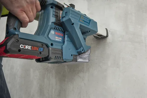 Bosch BULLDOG GBH18V-22 power tool with CORE 18V battery drilling into a concrete wall.