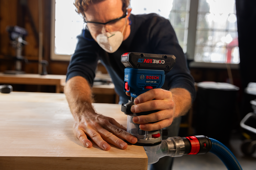 Bosch cordless palm router GKF18V-25 model application image on wood working.
