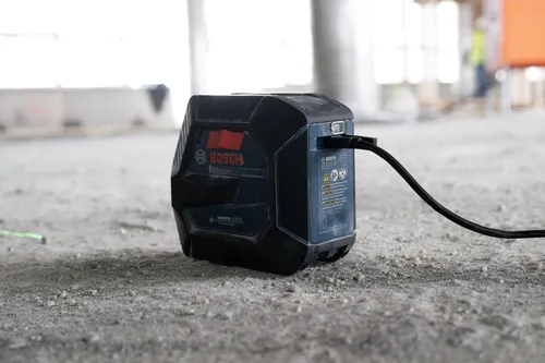 Bosch Professional GCL165-42G GreenLaser Technology tool, connected to a black cable on a construction site.