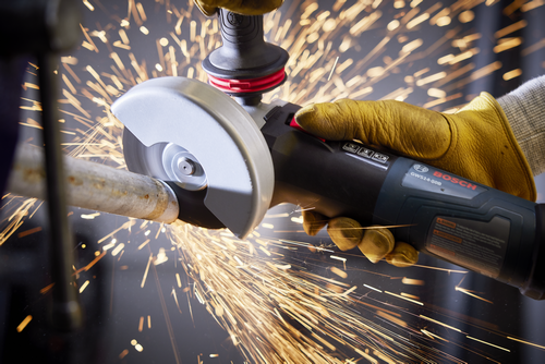Bosch GWS14-50B angle grinder cutting a metal pipe with sparks flying.