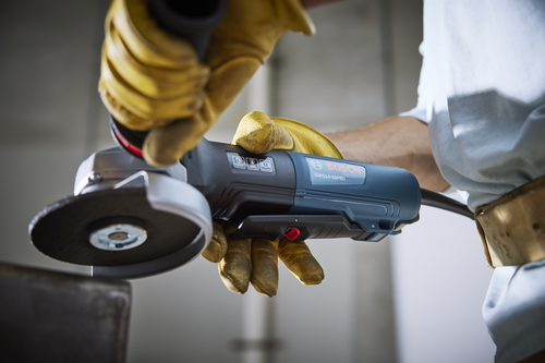 Bosch GWS14-50PBD angle grinder held by a person wearing yellow gloves.
