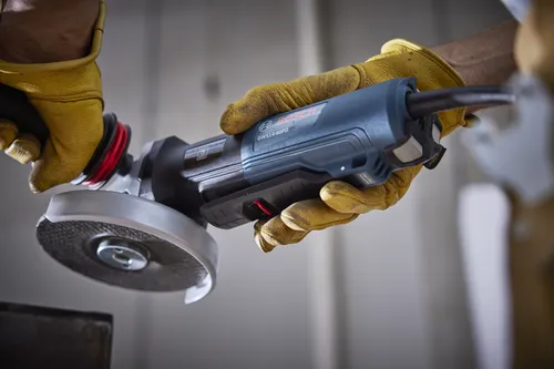 Bosch GWS14-60PD angle grinder, held by gloved hands.