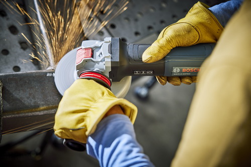 Bosch GWX14-60PBD angle grinder in use, with sparks flying during metalworking; gloved hands are holding the tool.