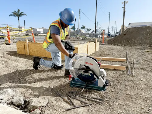 Bosch GCD18V-14N Dry Cut Saw application image on metal cutting.