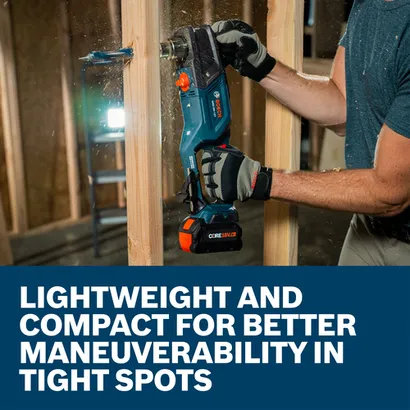 A worker using a Bosch GRD18V-127 18V High Torque Right Angle Drill to drill a hole through wood framing.
