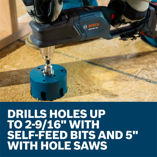 A worker using a Bosch GRD18V-127 18V High Torque Right Angle Drill to drill a hole in a wood floor with a hole saw.