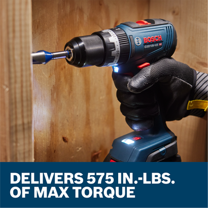 A worker drilling a hole into wood framing with the Bosch GSB18V-65 1/2 In. Brushless Hammer Drill/Driver.