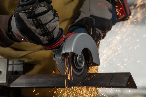 The worker holding the Bosch GWS18V-11S 18V Brushless 4-1/2 – 5 In. Angle Grinder with Slide Switch for cutting steel.