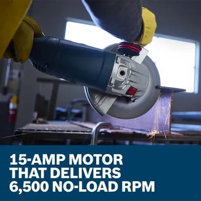 A worker is cutting a metal beam with a Bosch GWS25-230JR 9 In. Large Angle Grinder in a metal shop.