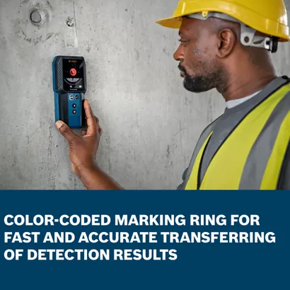 The worker using the Bosch GMS120-27 Wall Scanner to detect in a building wall.