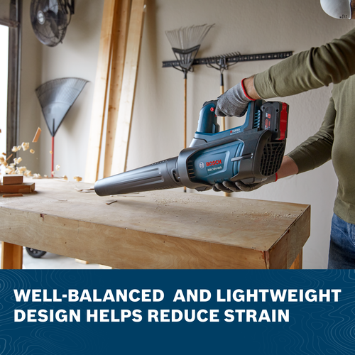 Image of worker blowing sawdust with the Bosch GBL18V-450N PROFACTOR™ 18V Blower on a workshop.