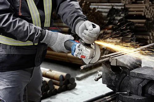 Worker using the Bosch GWX18V-8-2N 18V X-LOCK 4-1/2 In. Angle Grinder for cutting a steel rebar.