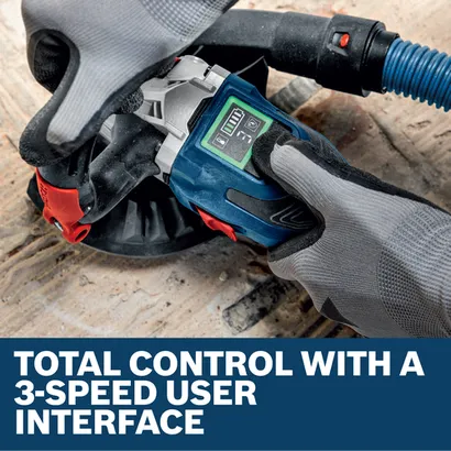 Image of worker using the Bosch GBR18V-15SN18X 5 In. 18V Concrete Surface Grinder on the concrete floor.
