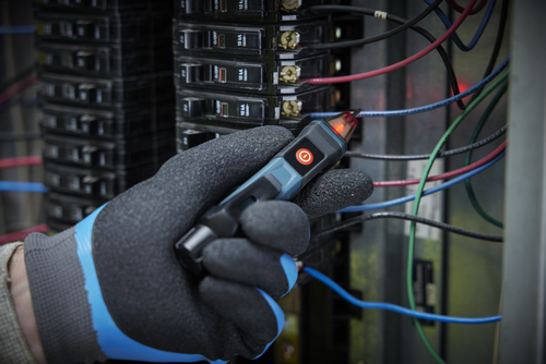 Application Image of worker using the Bosch GVD1000-15 Non-Contact Voltage Tester to check the voltage of electrical wires.