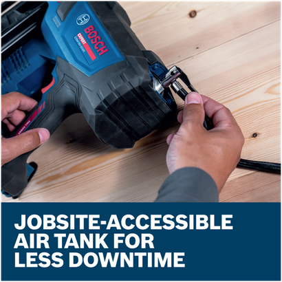 Close-up of hands connecting an air hose to a Bosch EXNH18V-90MRN EXPERT Framing Nailer on a wooden surface.