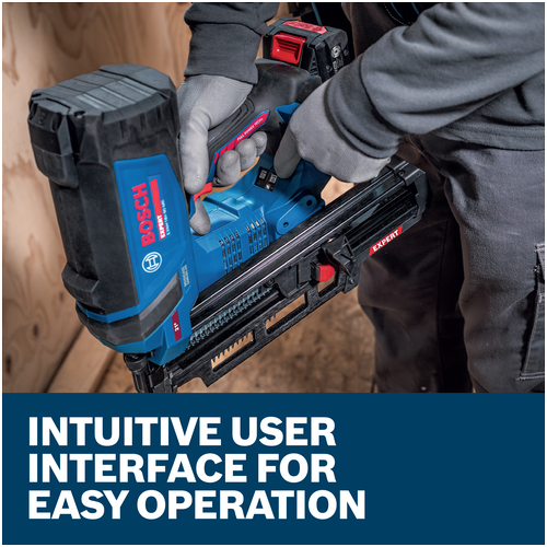 A worker wearing gloves holding a blue Bosch EXNH18V-90MRN EXPERT Framing Nailer on an interior residential jobsite.