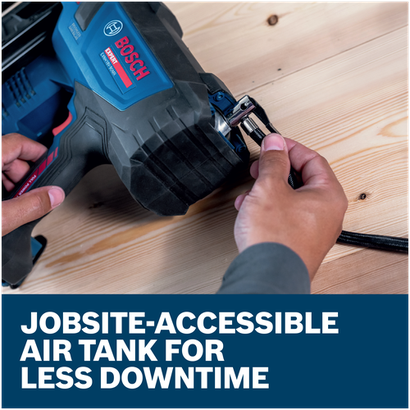Close-up of hands connecting an air hose to a Bosch EXNH18V-90MRB14 EXPERT Framing Nailer on a wooden surface.