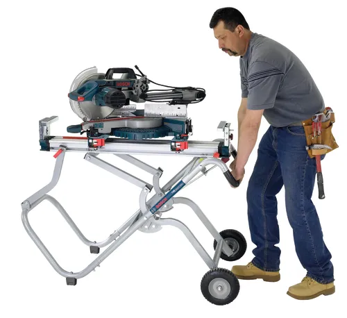 Application Image of worker holding a Bosch T4B Gravity-Rise Miter Saw Stand with Wheels on a white background.