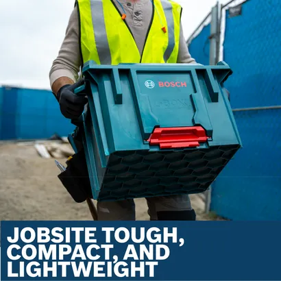 Worker in hi-vis vest carrying a Bosch L-Boxx contractor tool crate on a construction site.