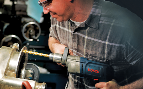 Person using a drill with the Bosch logo on it, drilling into a metal object.